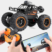 Toy monster truck with remote control and smartphone app interface on a white background
